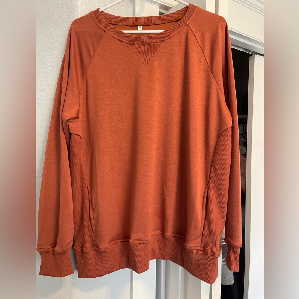 New without tags, pumpkin color crew neck with pockets!